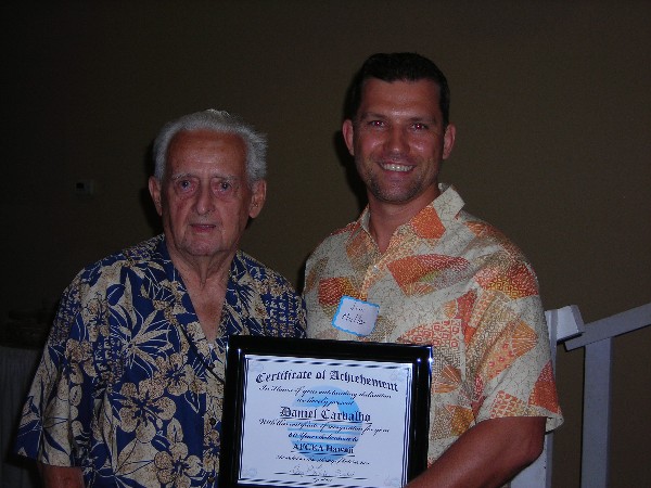 Jim Muller (r), chapter vice president of membership, recognizes Daniel Carvalho for his 60 years of dedication to the chapter at the October event.